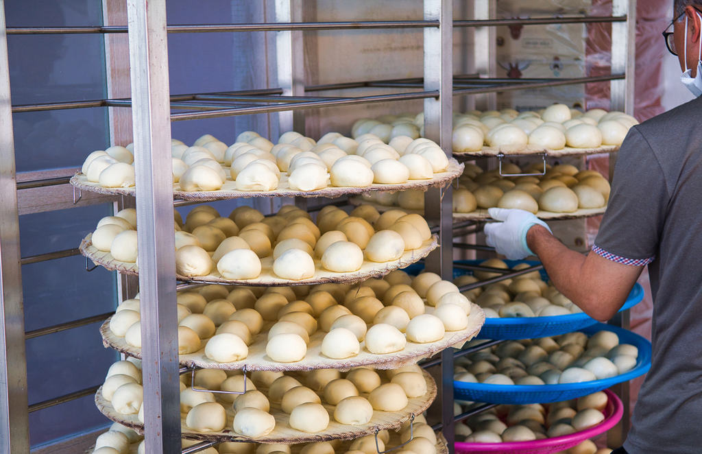 Freshly made Anheung jjinppang (steamed buns) are arranged on large racks at Anheung Jjinppang Village in Hoengseong, Gangwon Province, South Korea.
