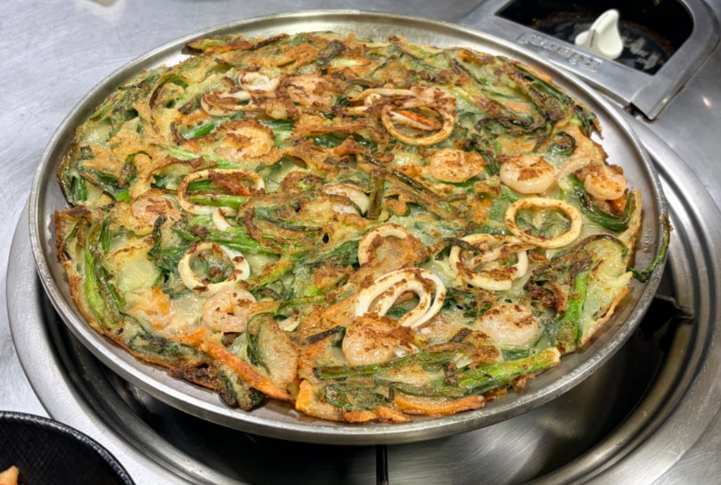 Haemul pajeon adds seafood such as squid, shrimp, oysters, or mussels to green onions and batter
