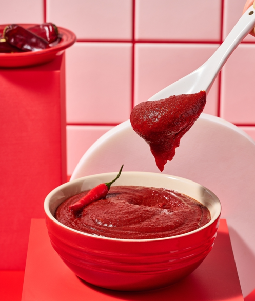 A spoonful of gochujang (고추장), Korea’s thick, fermented red chili paste.