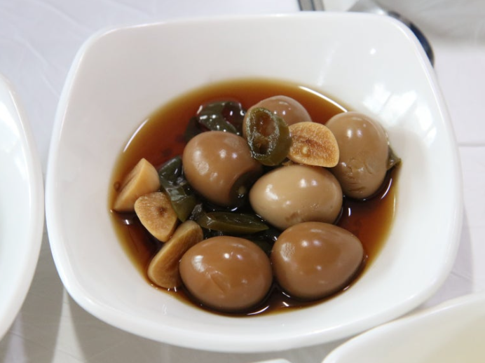 Mechurial jangjorim (메추리알 장조림), quail eggs braised in soy sauce with garlic and green chili peppers.